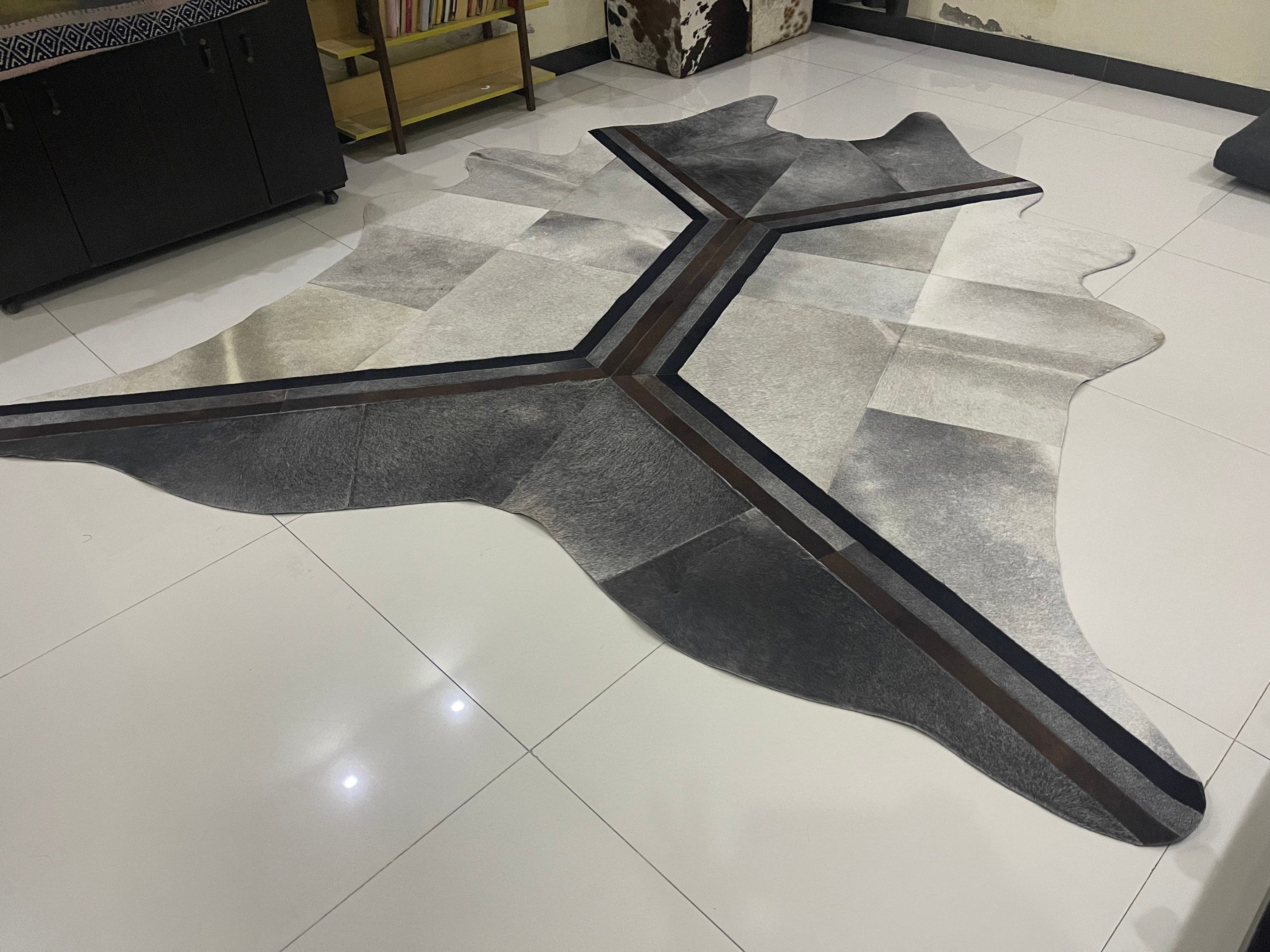 Cowhide Patch Rug ins the shape of real Brazilian cowhide shape designer cowhide patch rug . 115" x 96"